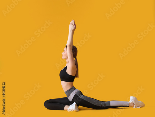 Sporty young woman doing yo...