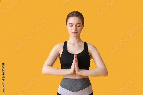 Sporty young woman doing yo...