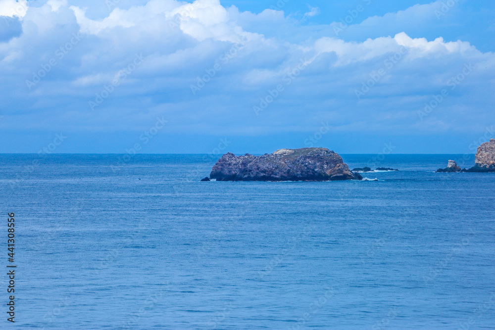 Idyllic solitude island with green trees in the ocean, ixtapa