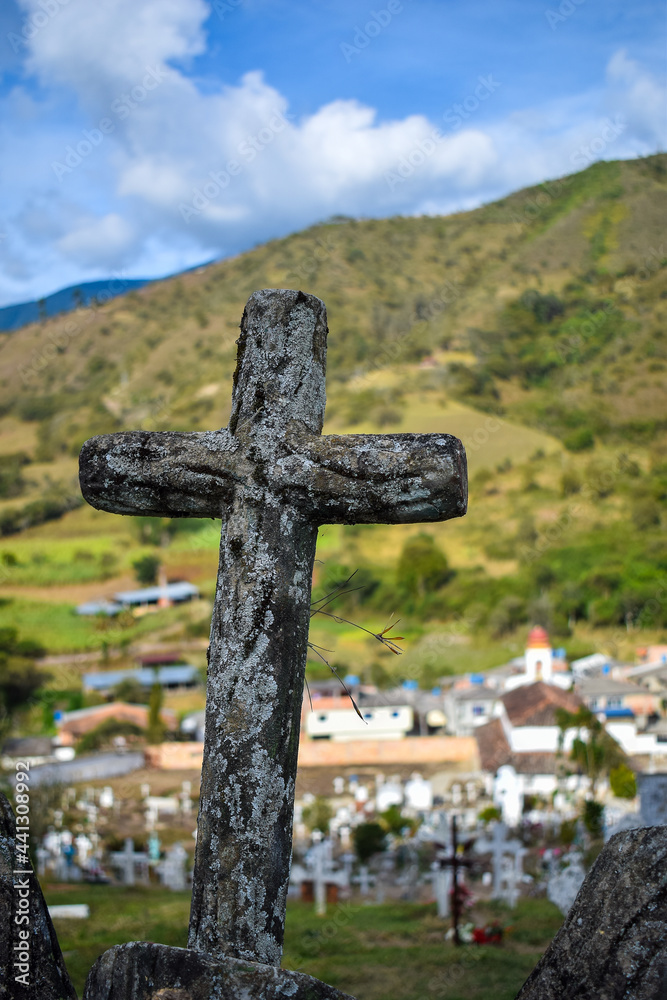 wooden cross in a cemetery with mountain in the background wooden cross in a cemetery with mountain in the background