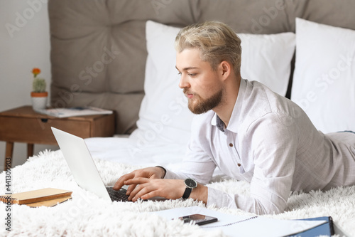 Young man studying online a...