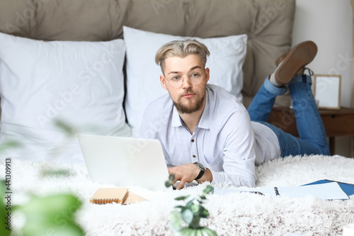 Young man studying online a...