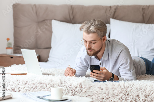 Young man studying online a...