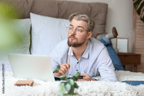 Young man studying online a...