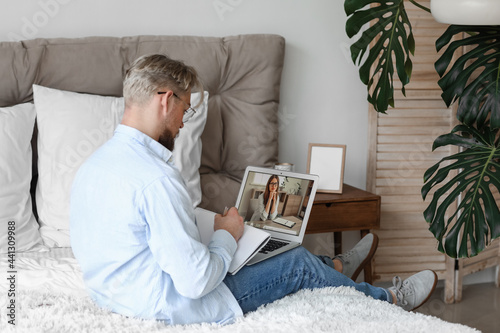 Young man studying online a...