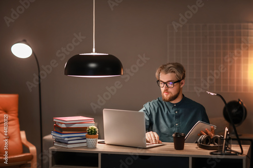 Young man studying online a...