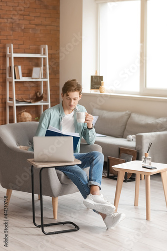 Young man reading book and ...