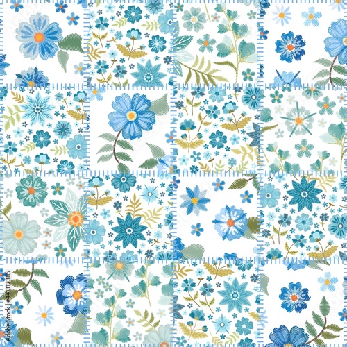 Seamless patchwork pattern from patches with embroidered light blue flowers on white background