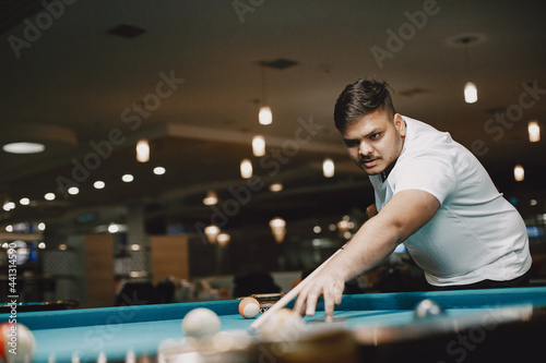 Man playing billiards in a club