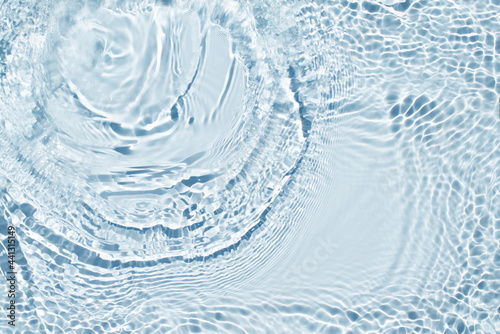 Water spills on a light blue background. Natural sunlight and shade. Beautiful burst. Summer mood. Minimal style.