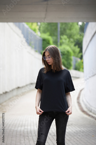 Woman or girl wearing black blank cotton t-shirt with space for your logo, mock up or design in casual urban style Free Download Woman or girl wearing black blank cotton t-shirt with space for your logo, mock up or design in casual urban style - GFXLoad