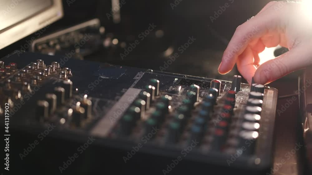 Sound operator hands at the volume control panel Sound operator hands at the volume control panel