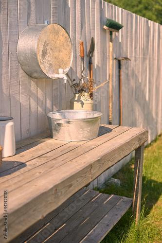 summer washbasin on the street in a country house in the backyard with a white wooden fence
