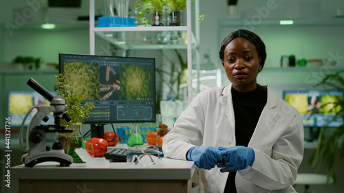 Pov of botanist researcher woman explaining botany experiment during online videocall meeting while sitting in pharmaceutical lab. Specialists team researching genetic mutation developing dna test