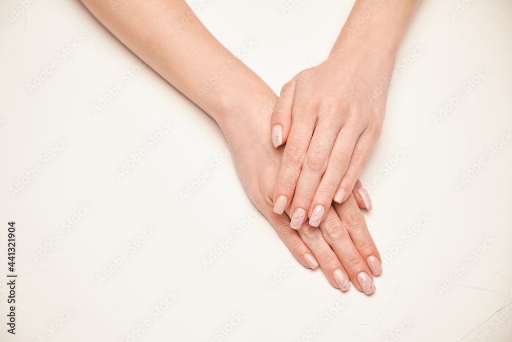 Woman hands with beautiful manicure on light background Woman hands with beautiful manicure on light background