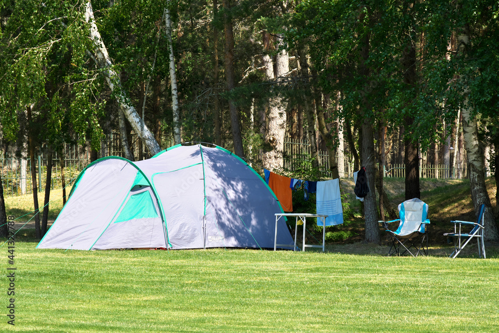 Large tent in the forest. Equipped place for tourists with tents