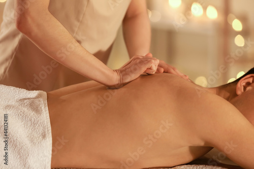 Young man having massage in spa salon