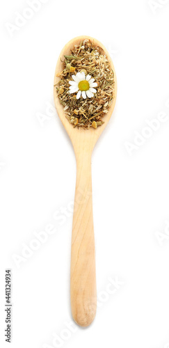 Spoon with dried chamomile flowers on white background