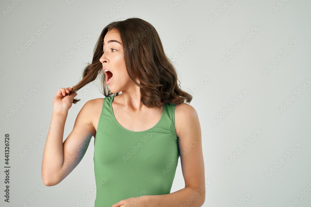 pretty brunette with open mouth in green tank top emotions cropped view pretty brunette with open mouth in green tank top emotions cropped view