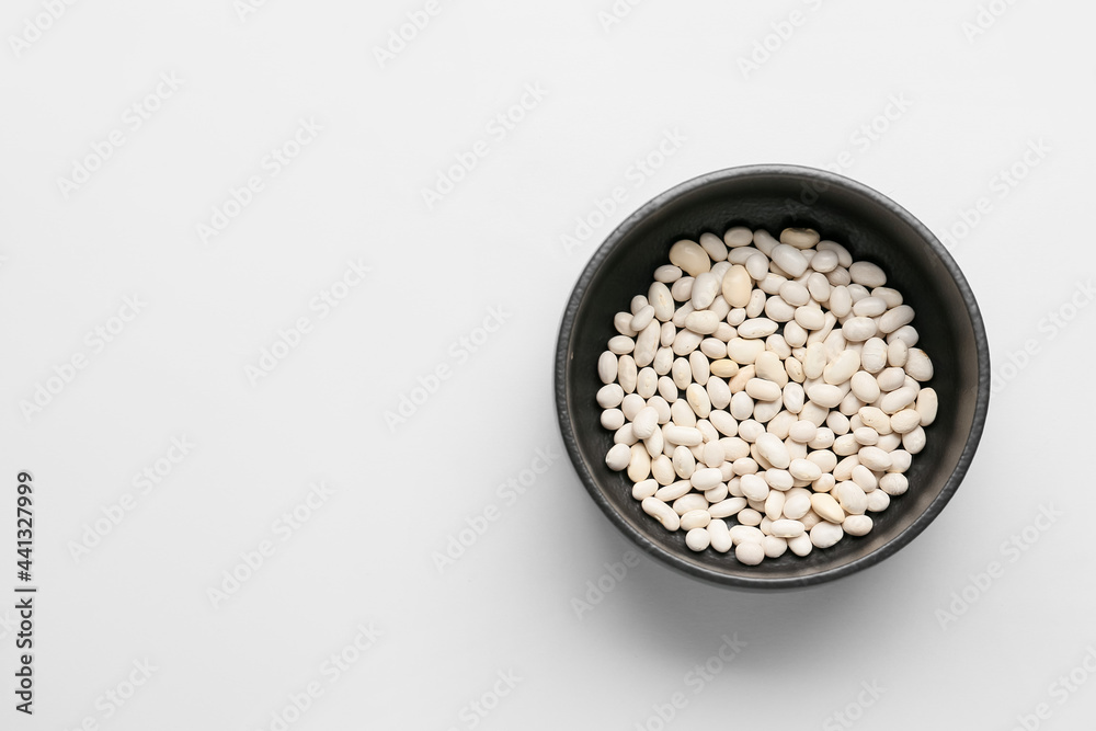 Bowl with beans on white background. Concept of racism Bowl with beans on white background. Concept of racism