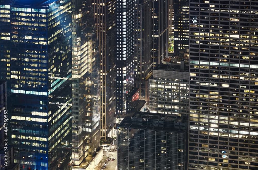 Aerial view of office buildings in Manhattan at night, New York City, USA.