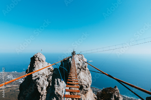 a hinged bridge high in the mountains of Crimea Ai-Petri. The sea in the background Horizontal photo photo