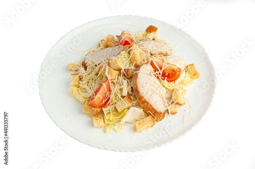 Caesar salad with Chinese cabbage. In a white plate. View from above. White background. Isolated
