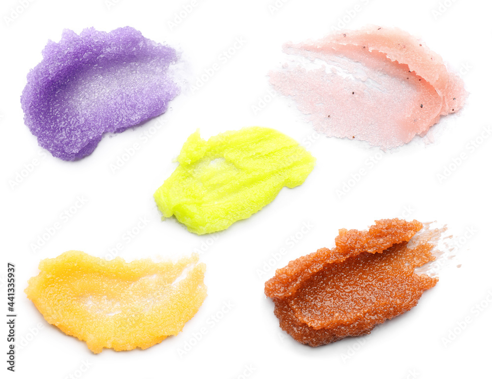 Set with smears of different body scrubs on white background Set with smears of different body scrubs on white background