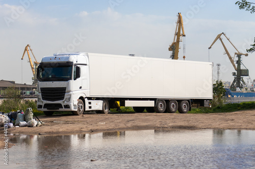 big white truck on the background of sea tugs