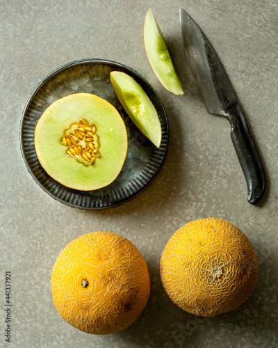Fényképezés Honeydew melon on a grey background.