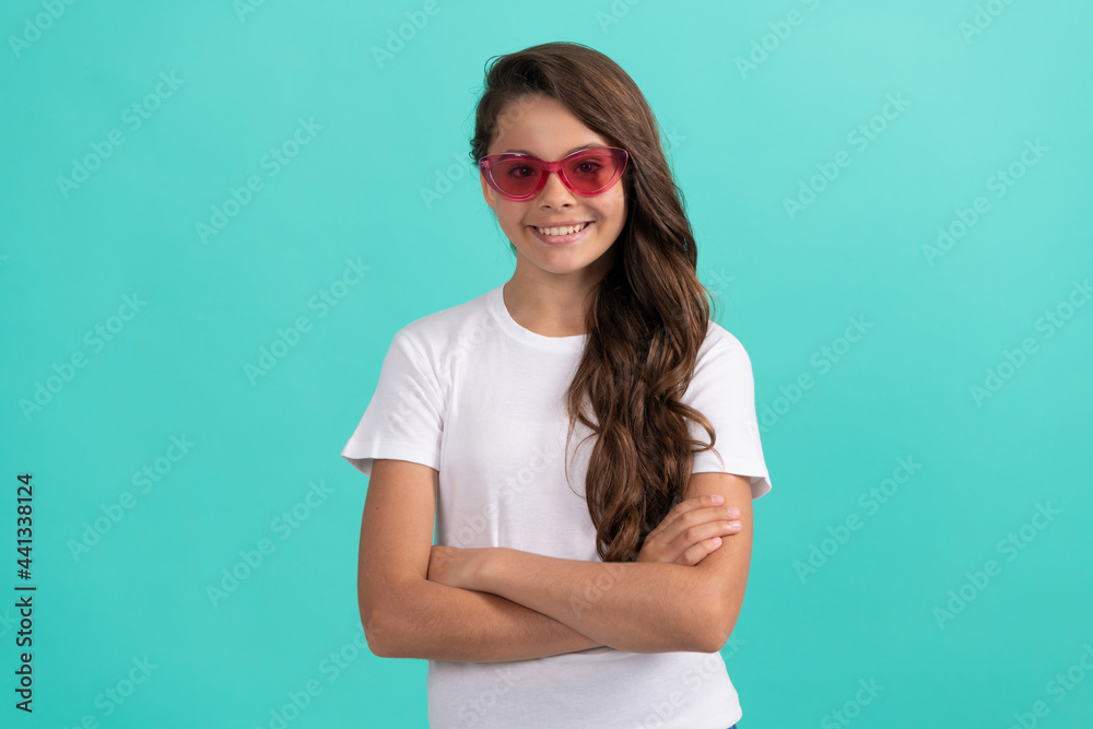 smiling child long curly hair in sunglasses casual style on blue background, fashion accessory smiling child long curly hair in sunglasses casual style on blue background, fashion accessory