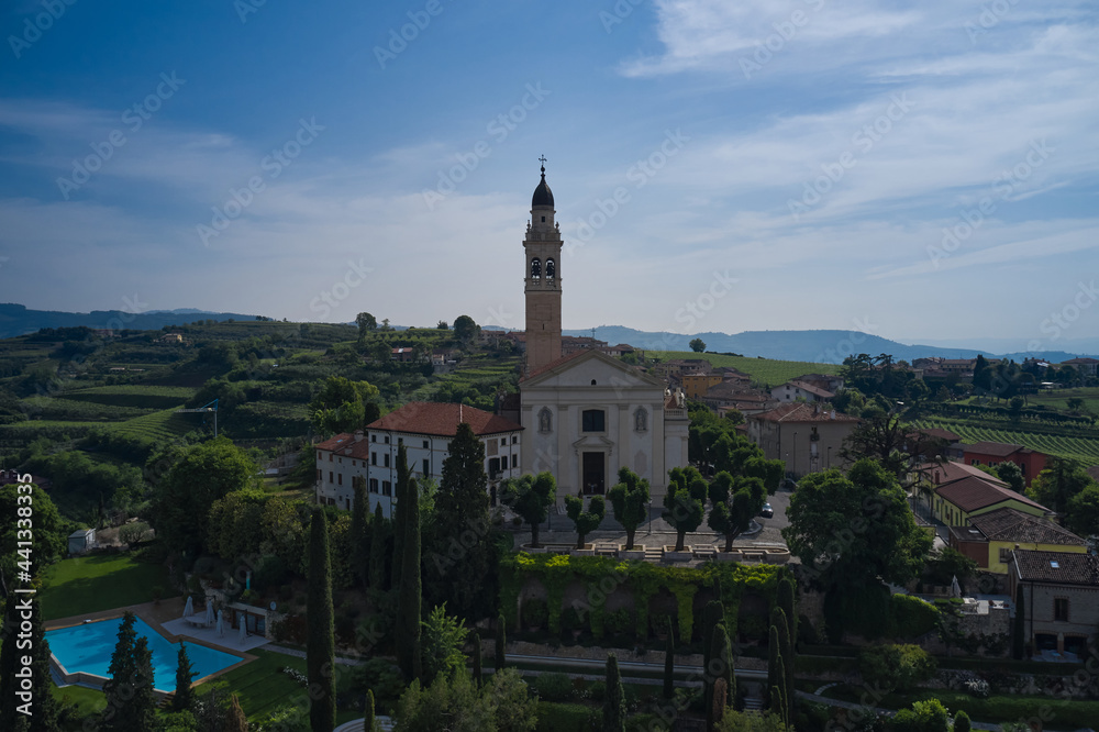 Parish Church of Saints Fermo and Rustico, on a hill in the province of Verona, Colognola Ai Colli, Italy. Catholic church on a hill surrounded by vineyards.