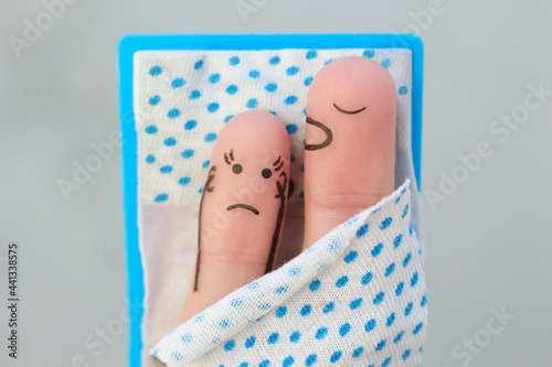 Fingers art of couple in bedroom. Concept of snoring husband annoys his wife. photo