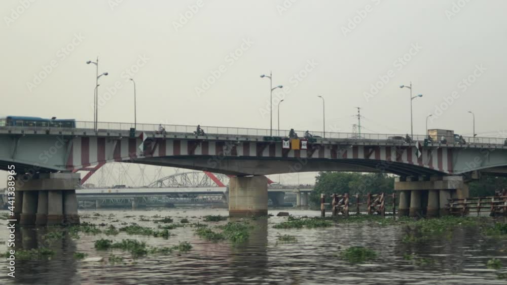 Bridge over Saigon river with moving vehicles in Ho Chi Minh City, Vietnam Bridge over Saigon river with moving vehicles in Ho Chi Minh City, Vietnam