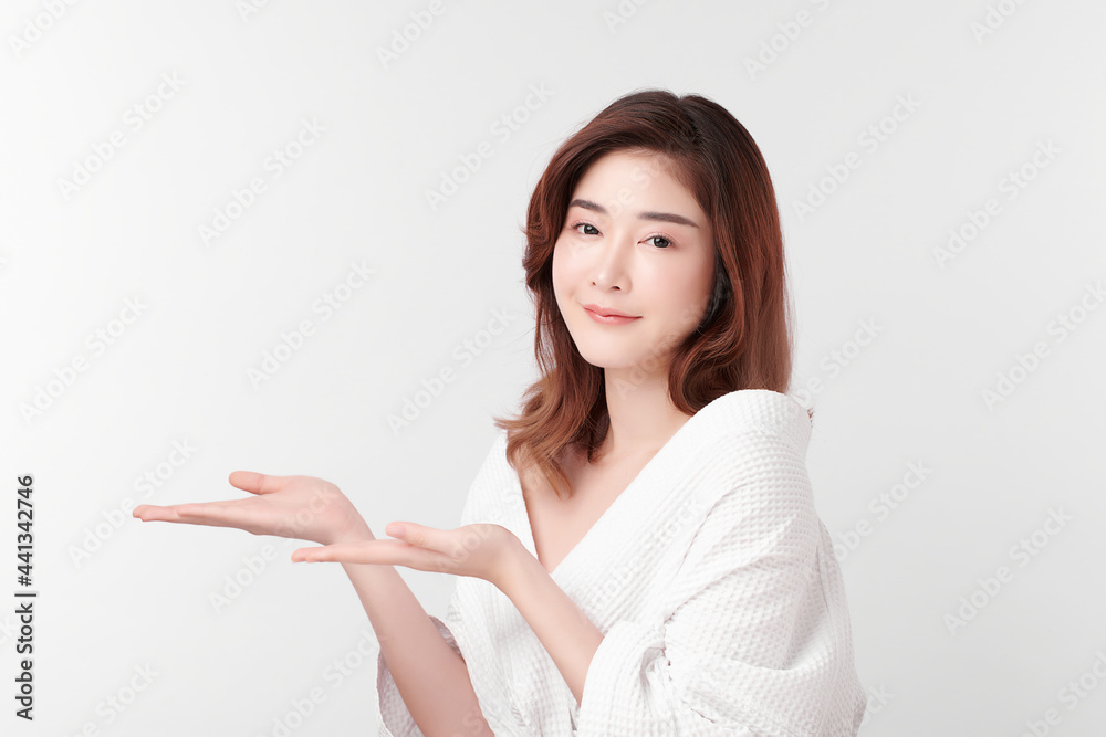 Beautiful young Asian woman wearing bathrobe on white background, Face care, Facial treatment, Cosmetology, beauty and spa Concept. Beautiful young Asian woman wearing bathrobe on white background, Face care, Facial treatment, Cosmetology, beauty and spa Concept.