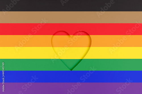 LGBTQ pride flag background. Rainbow Printed cardboard with die-cut heart shape