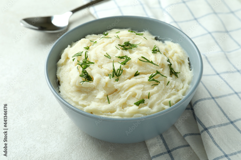 Bowl of mashed potatoes on white textured background Bowl of mashed potatoes on white textured background
