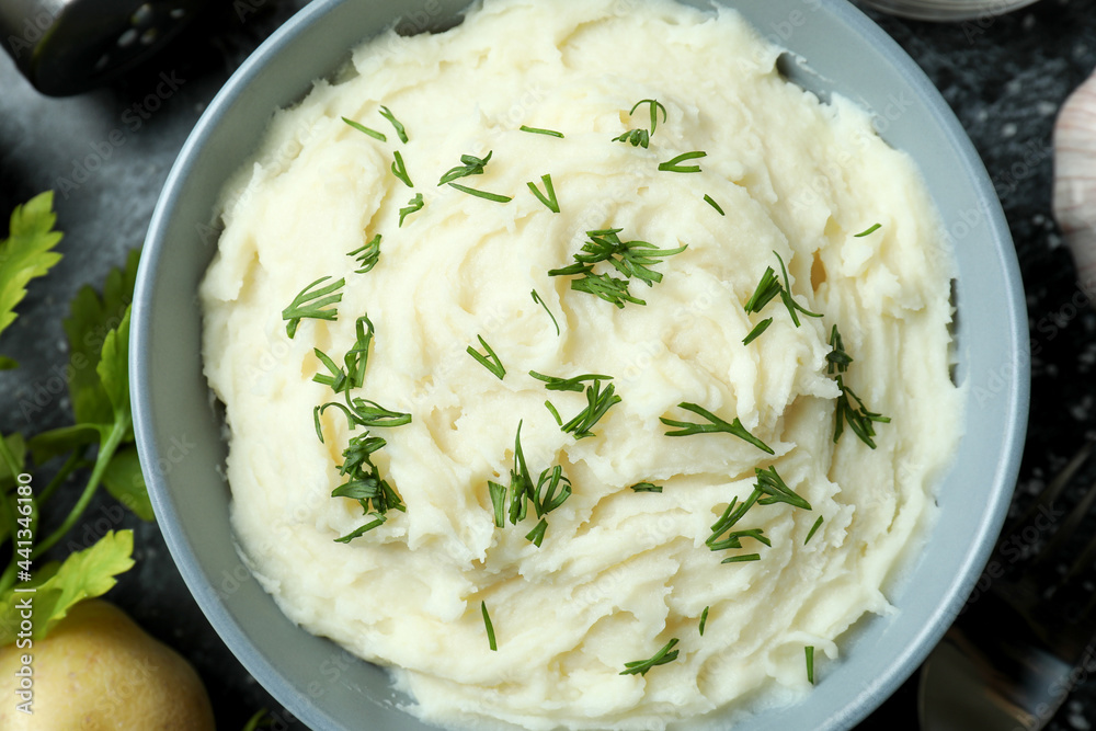 Concept of tasty eating with mashed potatoes on black smokey table Concept of tasty eating with mashed potatoes on black smokey table