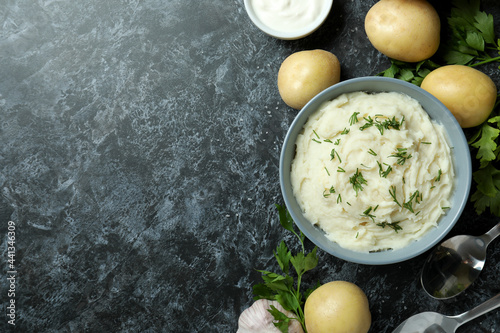 Photography Concept of tasty eating with mashed potatoes on black smokey table