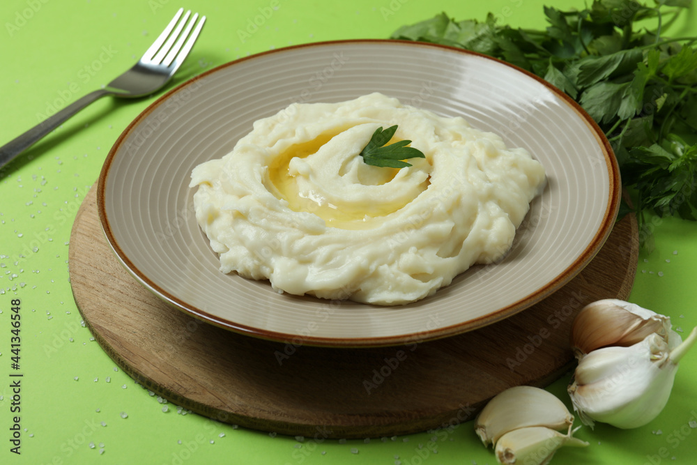 Concept of tasty eating with mashed potatoes on green background