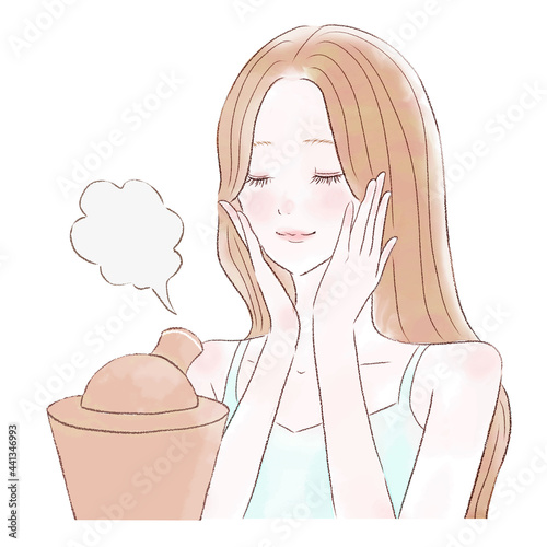 スチーマーで顔を保湿する女性