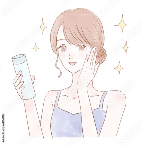 化粧品の効果のイメージ 化粧水を持つ笑顔の女性