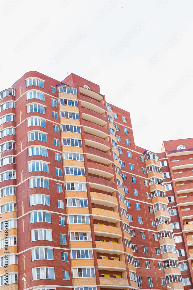 windows on colorful building, red brick multi-storey house, brick house,