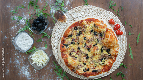 Pizza with fluffy top, tomatoes, olives, green peppers, cheese, fresh from the oven