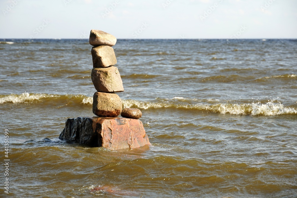 Rock balancing in Gulf of Finland. stones on top of each other. Sea small waves. High quality photo Rock balancing in Gulf of Finland. stones on top of each other. Sea small waves. High quality photo
