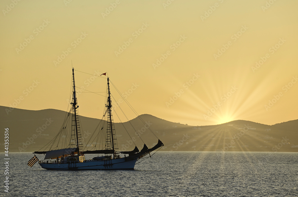 Schooner at anchor at sunset in the waters of Greece