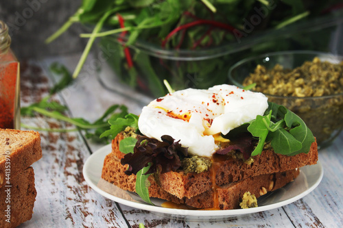 Homemade sandwiches with pesto  green salad and poached eggs