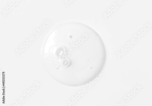 Clear transparent circle spot with bubbles cosmetic product texture isolated on white background. Facial serum smear, shower gel smudge, shampoo, essence swatch