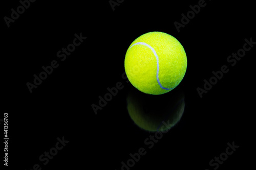tennis ball isolated on black with reflection © Denis Shmunk