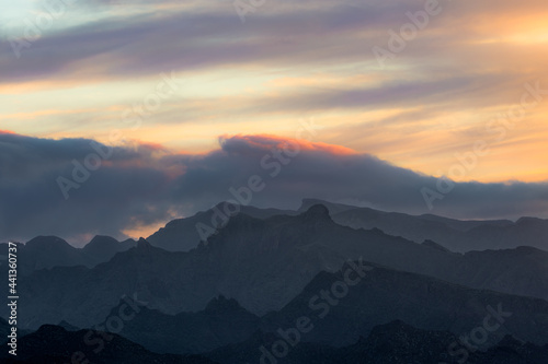 The outline of the mountains is drawn with the sun and clouds in the dawn light in Anaga  Santa Cruz de Tenerife  Canary Islands.